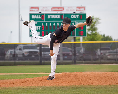 Young boy pitching in a baseball game